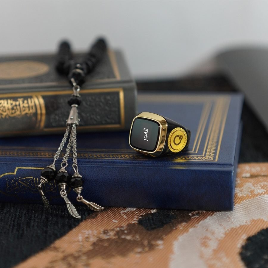 Bead tasbih and zikr ring resting on the Quran